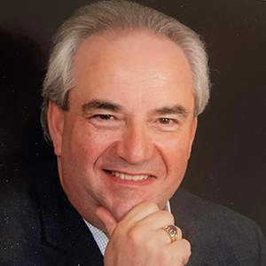Bill Bolling holding his right hand on his chin and smiling