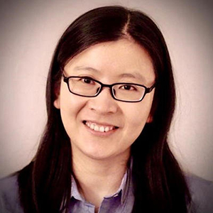 ​​​​​​​Fengxiu Zhang stands and smiles